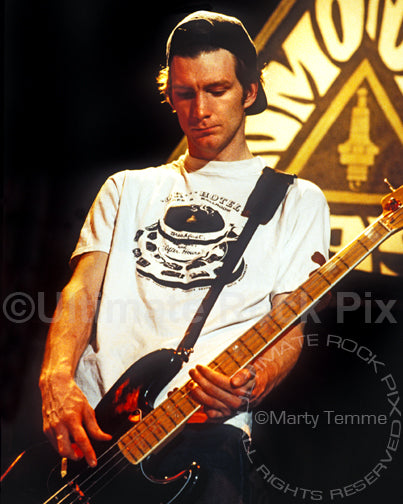Photo of bass player Ben Shepherd of Soundgarden playing a black Fender Bass in concert in 1991 by Marty Temme