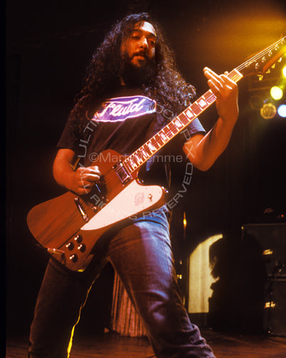 Photo of guitarist Kim Thayil of Soundgarden playing a Gibson Firebird in concert in 1991 by Marty Temme