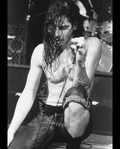 Black and white photo of Chris Cornell of Soundgarden kneeling onstage in 1992 by Marty Temme