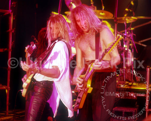 Photo of Chris Heilman and Spencer Sercombe of Shark Island onstage in 1988 by Marty Temme