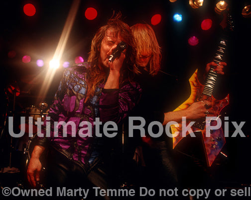 Photo of Richard Black and Spencer Sercombe of Shark Island performing onstage in 1989 by Marty Temme