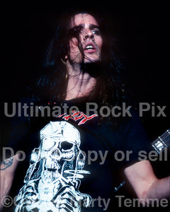 Photo of Rachel Bolan of Skid Row in concert in 1989 by Marty Temme