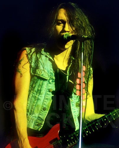 Photo of Scotti Hill of Skid Row in concert in 1990 by Marty Temme