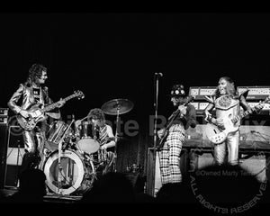 Photo of Don Powell, Dave Hill, Noddy Holder and Jim Lea of Slade in concert in 1973 by Marty Temme