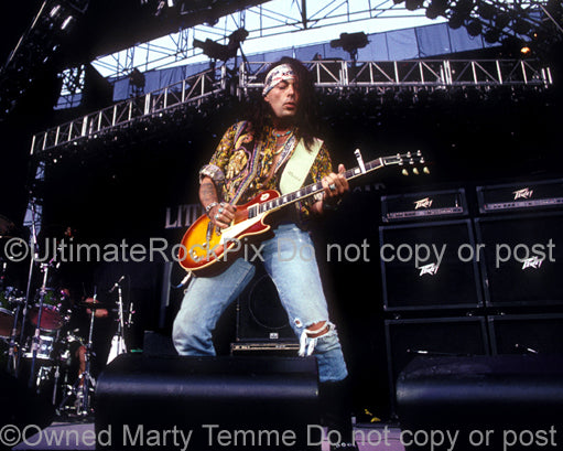 Photo of Earl Slick playing a Les Paul in concert in 1991 by Marty Temme
