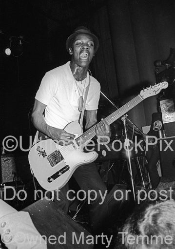 Photo of Lynval Golding of The Specials in concert in 1980 by Marty Temme