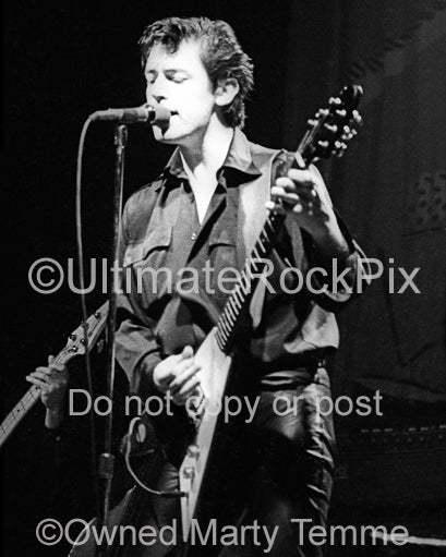 Photo of Chris Spedding playing his Gibson Flying V in concert in 1979 by Marty Temme