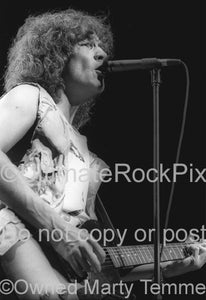 Black and white photo of Billy Squier singing in concert in 1984 by Marty Temme