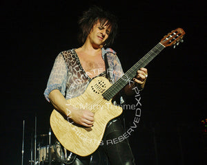 Photo of Steve Stevens playing a Godin guitar in concert by Marty Temme