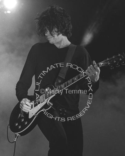Black and white photo of Dean DeLeo in concert by Marty Temme