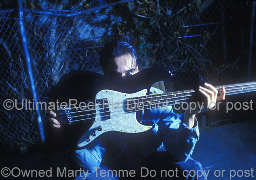 Photo of Robert DeLeo of Stone Temple Pilots holding his bass guitar during a photo shoot by Marty Temme