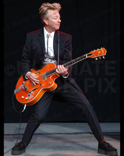Photo of Brian Setzer of The Stray Cats onstage with his Gretsch guitar by Marty Temme