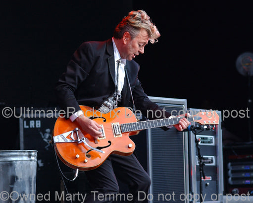 Photo of Brian Setzer of The Stray Cats in concert with his Gretsch guitar by Marty Temme