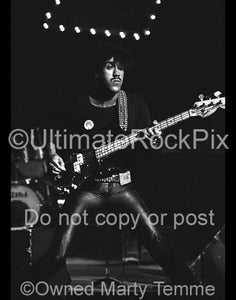 Photo of Phil Lynott of Thin Lizzy in concert in 1977 by Marty Temme