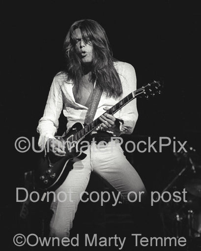Photo of Scott Gorham of Thin Lizzy in concert in 1977 by Marty Temme