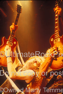 Photo of guitar players Luke Morley and Ben Matthews of Thunder in concert in 1991 by Marty Temme