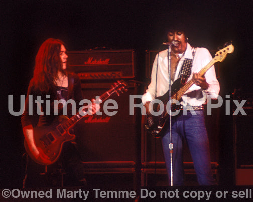 Photo of Gary Moore and Phil Lynott of Thin Lizzy in concert in 1977 by Marty Temme