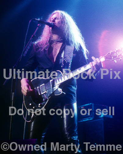 Photo of guitar player John Sykes of Thin Lizzy in concert in 2004 by Marty Temme