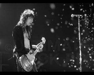 Black and white photo of Tom Keifer of Cinderella playing a Les Paul in concert by Marty Temme