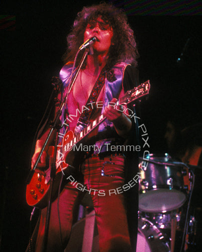 Photo of Marc Bolan of T. Rex playing a Les Paul in concert
