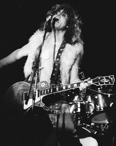 Black and white photo of Marc Bolan of T. Rex playing a Les Paul in 1973 by Marty Temme