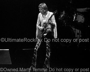 Black and white photo of Robin Trower playing a Gibson SG in concert in 1977 by Marty Temme