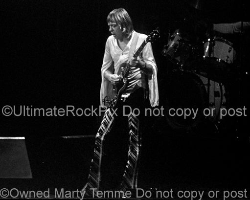 Black and white photo of Robin Trower playing a Gibson SG in concert in 1977 by Marty Temme
