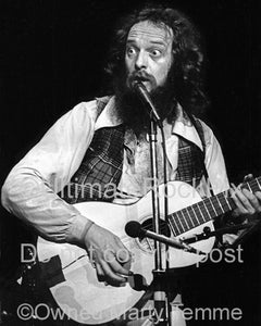 Photo of Ian Anderson of Jethro Tull playing guitar in 1979 by Marty Temme