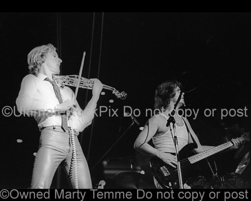 Photo of Eddie Jobson and John Wetton of the band U.K. in concert in 1979 by Marty Temme