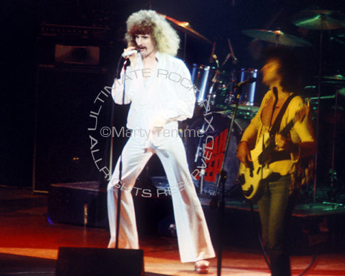Photo of David Byron and John Wetton of Uriah Heep in concert in 1976 by Marty Temme
