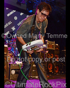 Photo of guitar player Steve Vai performing onstage in 2012 by Marty Temme