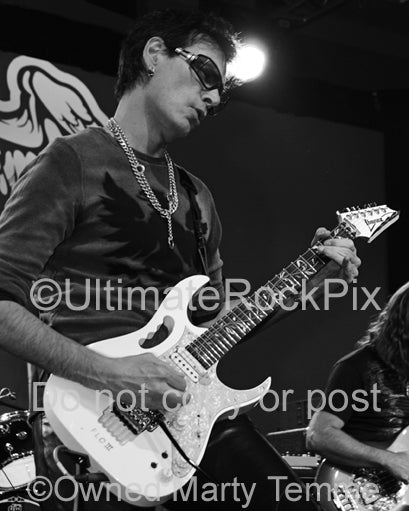 Black and white photo of guitar player Steve Vai in concert in 2012 by Marty Temme