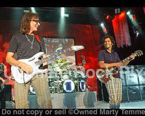 Photo of guitar players Dweezil Zappa and Steve Vai onstage in 2009 by Marty Temme