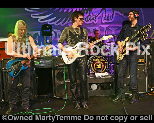 Photo of Steve Morse, Steve Vai and Paul Gilbert performing together in concert in 2012 in Anaheim, California by Marty Temme