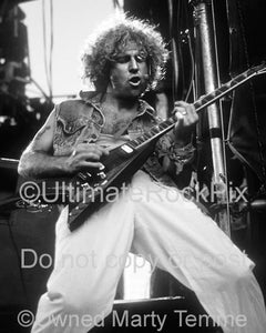 Black and white photo of Sammy Hagar of Van Halen playing guitar in concert in 1986 by Marty Temme