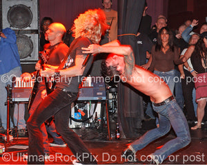 Photo of Scott Weiland and Duff McKagan of Velvet Revolver in concert in 2006 by Marty Temme