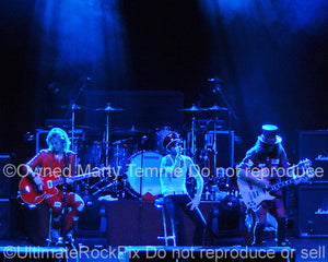 Photo of Scott Weiland, Duff Mckagan and Slash of Velvet Revolver in concert in 2008 by Marty Temme