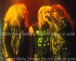 Photo of Jamie St. James, Jani Lane and Paul Shortino together onstage in 1989 by Marty Temme