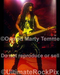 Photo of Jerry Dixon of Warrant in concert in 1989 by Marty Temme