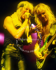Photo of Jani Lane and Joey Allen of Warrant in concert in 1989 by Marty Temme