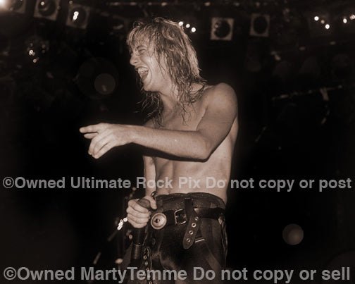 Sepia tint black and white photo of Jani Lane of Warrant in concert in 1988 by Marty Temme