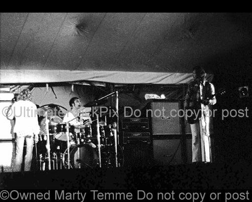 Photo of Pete Townshend, Roger Daltrey and Keith Moon of The Who in concert in 1971 by Marty Temme