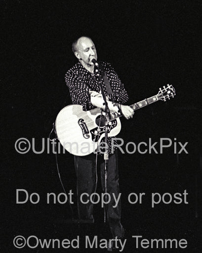 Photo of Pete Townshend of The Who playing a Gibson acoustic guitar in concert in 2000 by Marty Temme