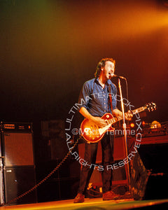 Photo of Pete Townshend of The Who playing a cherry sunburst Gibson Les Paul Deluxe in concert in 1980 by Marty Temme