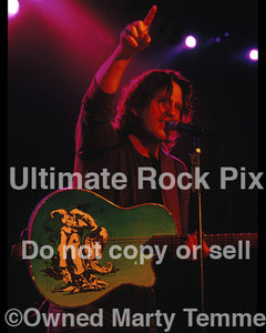 Photo of Kip Winger playing acoustic guitar in 2005 by Marty Temme