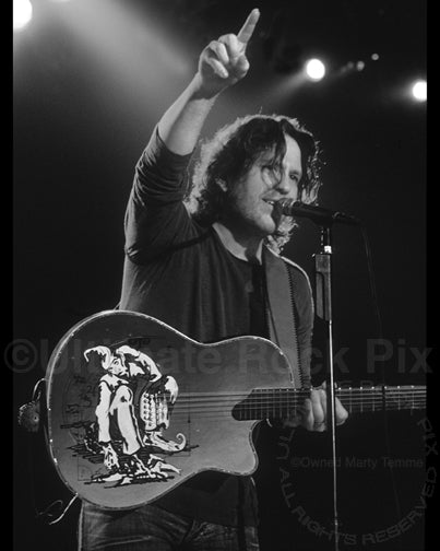Black and white photo of Kip Winger playing acoustic guitar in 2005 by Marty Temme