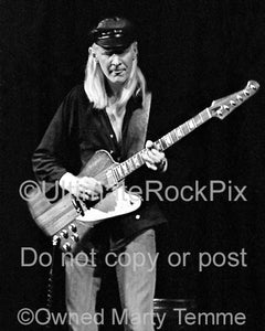 Photo of Johnny Winter playing his Firebird in concert in 1979 by Marty Temme