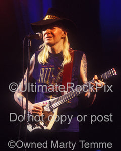 Photo of Johnny Winter playing his Lazer guitar in concert in 1998 by Marty Temme