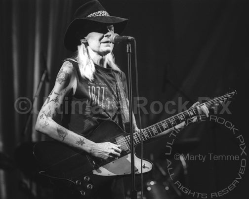 Photo of Johnny Winter playing his Gibson Firebird in concert in 1998 by Marty Temme