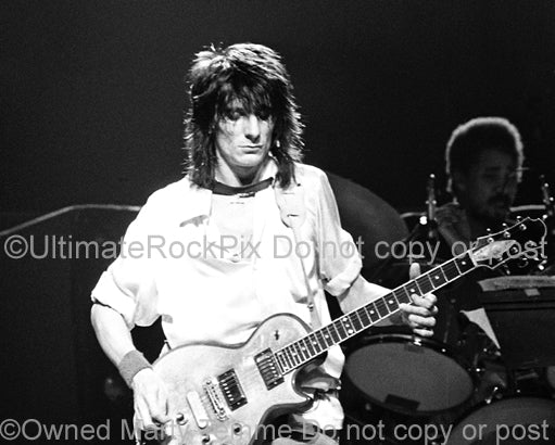 Black and white photo of Ron Wood of The Rolling Stones playing a Zemaitis guitar in concert in 1979 by Marty Temme